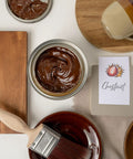 No Sweat Oil Base Gel Stain In Chestnut shown in a jar with a brush, perfect for DIY projects and enhancing wood surfaces.