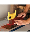 Keep Your Feed Locked Down Rock Solid Vertical Feather Board For Router Tables And Table Saws T Track Compatible adjustable polymer fence in use on wood.