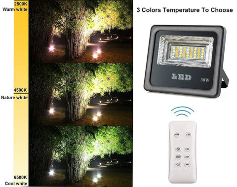 JUDYSSY 30W Led Solar Powered Flood Lights showing remote control and three color temperature options outdoors.