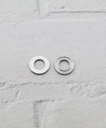 Close-up of two chrome steel thrust ball bearings, 8x16x5mm, single-direction miniature bearings.