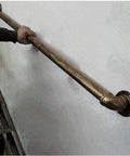 Street Tough Industrial Pipe Railing Kit With Galvanized Steel And Antique Brass Finish Stair handrail being installed on a wall.