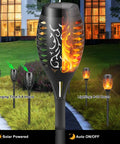 Solar Torch Lights With A Lit Flickering Flame Effect Outdoor Pathway Lights IP65 Waterproof in garden setting at night