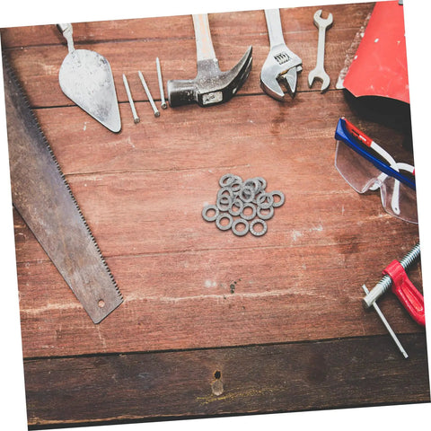 Built Tough Manganese Steel Wedge Locking Washers on a workbench next to tools and safety glasses, ideal for machinery.