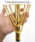 Hand holding 7 Inch Heavy Duty Metal Triangle Furniture Leg with gold finish, part of set for sofa, dresser, or cabinet.