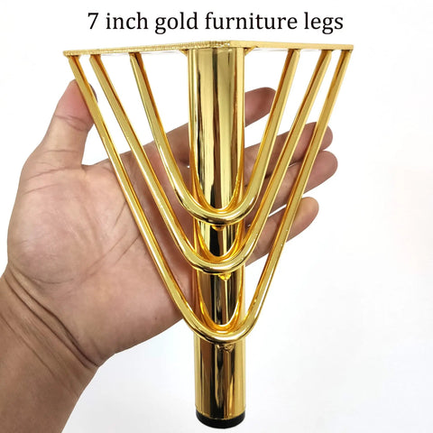 Hand holding 7 Inch Heavy Duty Metal Triangle Furniture Leg with gold finish, part of set for sofa, dresser, or cabinet.
