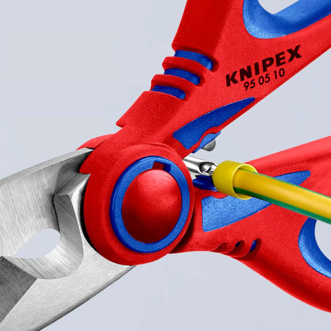 Close-up of Electricians Shears With Fine Serrated Blades And Integrated Cable Cutter, cutting a yellow wire, 160 mm size.