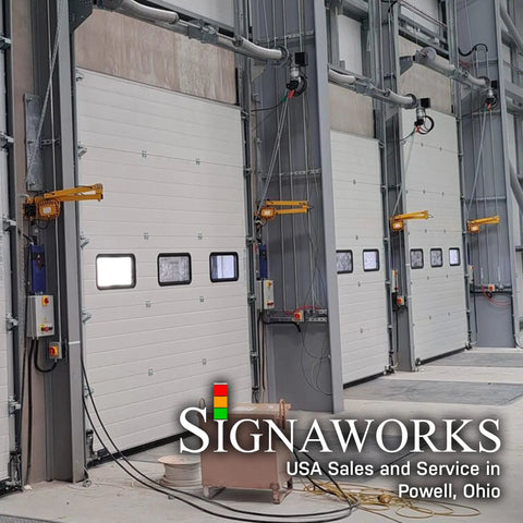 Heavy Duty Led Loading Dock Swing Arm Light 2 Pack mounted to loading dock doors for bright industrial lighting.