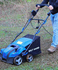 Man using a 16 Inch Dethatcher And Scarifier For Lawn, Electric Walk Behind Tool With 15 Amp Copper Motor on grassy lawn