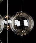 Close-up of the Five-Light Modern Crystal Chandelier with Spiral Raindrop Style Pendant light globe in focus against a black background.