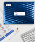 Top Notch Easy Peel Address Labels With Sure Feed Tech For Laser Printers 1.33 By 4 Inches White on a blue bubble envelope.