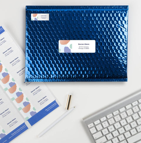 Top Notch Easy Peel Address Labels With Sure Feed Tech For Laser Printers 1.33 By 4 Inches White on a blue bubble envelope.