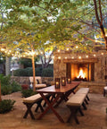 Outdoor patio with fireplace illuminated by 15 Pack Dimmable S14 LED Bulbs 2W 2700K Cozy Warm White on string lights overhead