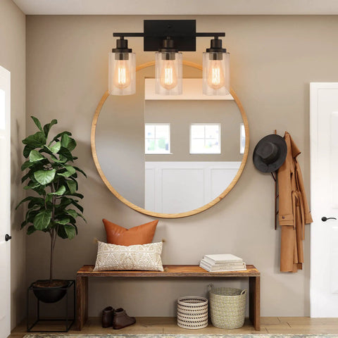 Matte Black 3 Light Vanity Wall Sconces With Clear Glass Shades above a mirror in a modern rustic hallway