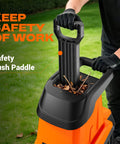 Person using safety push paddle on Powerful Electric Wood Chipper Shredder For Quick Yard Cleanup With 1800W Power, 4500 RPM