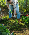 Gardener using 57 Inch 5 Tine Steel Garden Pitch Fork With Cushioned Grip Heavy Duty Mulch And Compost Fork Green Fiberglass Handle