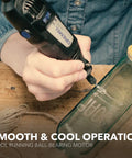Person using Two Speed Corded Rotary Tool Kit with 15 accessories and one attachment for glass etching project