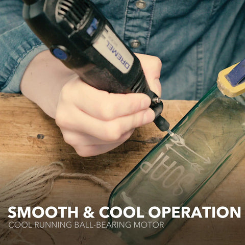 Person using Two Speed Corded Rotary Tool Kit with 15 accessories and one attachment for glass etching project
