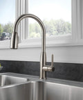 Apex Kitchen Integrated Pull Down Faucet With Single Handle Half Inch IPS Connection Water Efficient 1 GPM Flow ADA Compliant in stainless steel finish installed over a modern double sink in a contemporary kitchen.