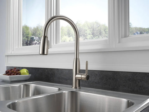 Apex Kitchen Integrated Pull Down Faucet With Single Handle Half Inch IPS Connection Water Efficient 1 GPM Flow ADA Compliant in stainless steel finish installed over a modern double sink in a contemporary kitchen.