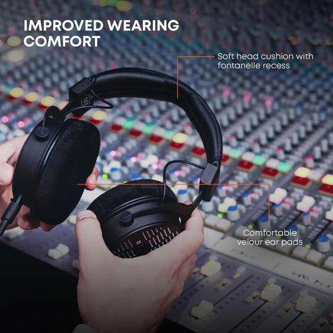 DT 1990 Pro MKII Open-Back Wired Studio Headphones For Mixing And Mastering, 30 Ohm, in studio with hands adjusting
