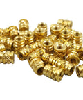 100 Pack Of M4 0.7 Long Threaded Heat Set Inserts For 3D Printing Brass Fasteners in a pile, showcasing detailed threading.