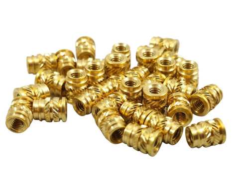 100 Pack Of M4 0.7 Long Threaded Heat Set Inserts For 3D Printing Brass Fasteners in a pile, showcasing detailed threading.