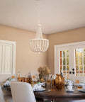 Dumas 3 Light Coastal Boho Chandelier With Weathered White Beads And Exposed Bulbs For A Cozy Vibe in dining room setting