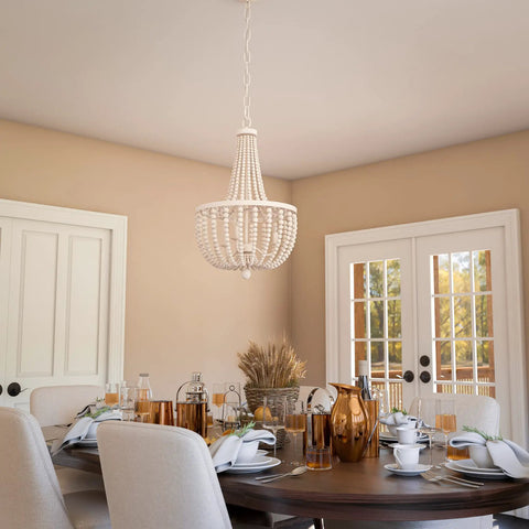 Dumas 3 Light Coastal Boho Chandelier With Weathered White Beads And Exposed Bulbs For A Cozy Vibe in dining room setting