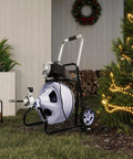 Kick Stubborn Clogs To The Curb With This Heavy Duty Electric Drain Cleaner on grass beside a Christmas tree, featuring a 480 watt motor.