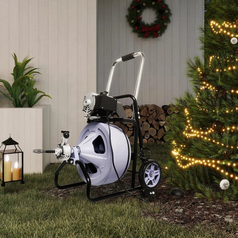 Kick Stubborn Clogs To The Curb With This Heavy Duty Electric Drain Cleaner on grass beside a Christmas tree, featuring a 480 watt motor.
