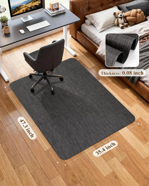 Big Non Slip Office Chair Mat For Hardwood Floors 35.4 X 47.2 Inches Heavy Duty PVC Floor Protector For Rolling Desk Chair Easy Glide With Rattan Pattern Black Home Office Rug Pad installed under desk chair in home office setting.