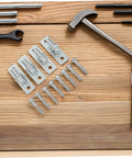 Heavy Duty Wall Mount Fence Gate Hinges For Sturdy Posts And Metal Doors Featuring Four Piece Wall Plate Hardware and screws on wood.