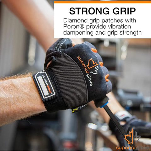 Person wearing leather half finger framers gloves large size black and orange with open fingertips using a tool