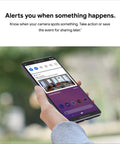 Hand holding phone displaying Instant Mobile Alerts feature of Indoor 1080p Security Cam With Night Vision, 24 Seven Live Video