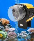 Dead Simple Automatic Fish Feeder With Battery Powered Digital Timer And Sleek LCD Panel For Foolproof Aquarium Care mounted on aquarium tank.