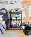 Three Tier Metal Rolling Cart On Wheels In Black in kids room next to bed, used as bedside table, holding toys and books.