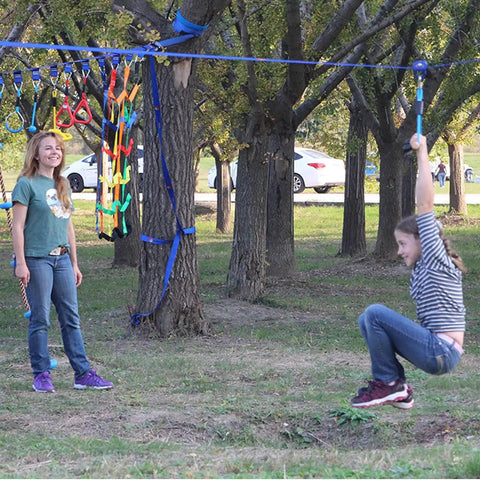Child on Heavy Duty Zip Line Pulley Kit With Smooth Glide Trolley For Backyard Fun And Fitness, obstacle course in use.