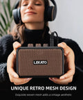 Person holding a Portable 5W Mini Guitar Amplifier With Dual Speakers, Rechargeable Bluetooth Practice Amp, brown mesh finish.