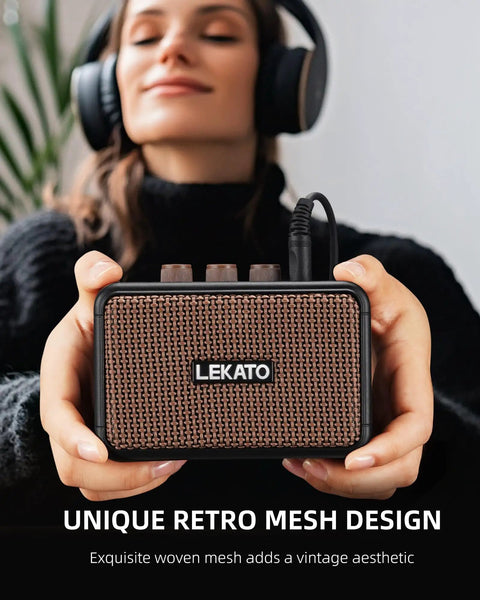 Person holding a Portable 5W Mini Guitar Amplifier With Dual Speakers, Rechargeable Bluetooth Practice Amp, brown mesh finish.