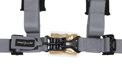 Close-up of gray 4 point harness with 2 inch straps and black buckle, part of Universal UTV Off Road Harness Kit