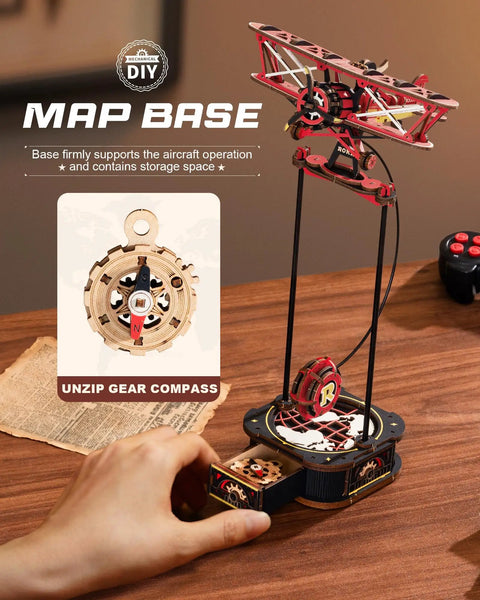 3D Wooden Puzzle For Grownups Gravity Swing Model Kit with biplane resting on a DIY map base, showing drawer with gear compass.