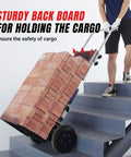 XSTO 550 Lb Capacity Electric Dolly Stair Climber carrying bricks up stairs with sturdy back board for cargo safety.