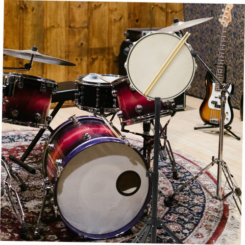 Slick Black Tripod Drum Stand With Heavy Duty Snare Rack And Practice Pad Holder Featuring Adjustable Heights Hella Portable For Bedroom Jamming Solid Build Quality Designed To Help Beginners Knock Out Clean Rhythms Daily with snare and practice pad visible.