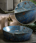 Slick Blue Ceramic Vessel Sink Featuring Hand Painted Vintage Design For Bathroom Vanity Tops easy clean no overflow, side view with floral details.