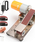 No Sweat Electric Mini Belt Sander And Knife Sharpener, featuring steel base, motor, and assorted sanding belts for precision work.