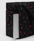 Underseat Travel Carry On Bag Built With Recycled Nylon Small Cloud Style Painted Wildflower Fits Under Airplane Seat And On Top Of Rollers Exterior Pockets For Quick Access Washable And Lightweight showing exterior pocket with laptop