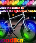 Rechargeable Bike Wheel Lights Set of 2 with Motion Sensor illuminating bike wheels in 7 color LED glow outdoors at night.