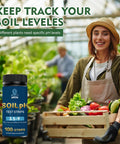 Gardener with fresh produce holding Soil PH Test Kit With Tubes And 100 Strips For Accurate 3.5 To 9 PH Readings in greenhouse