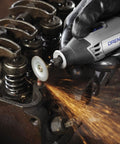 Close-up of EZ Lock Aluminum Oxide Rotary Tool Grinding Wheel Set in use, grinding metal edges with sparks flying