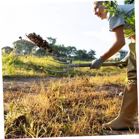 Person using Heavy Duty Steel Four Prong Pitch Fork For Digging And Loosening Soil Manure Rake With Easy Attach To Handle